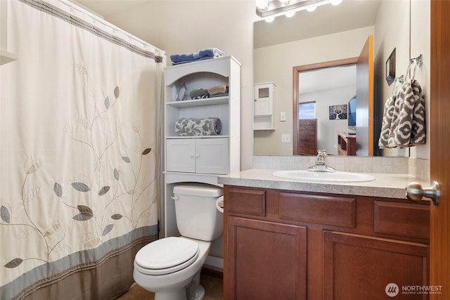bathroom featuring vanity, toilet, and a shower with shower curtain