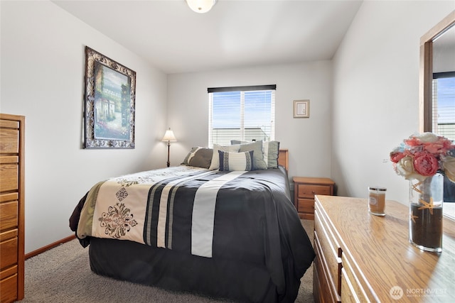 carpeted bedroom with multiple windows and baseboards