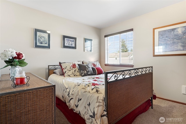 carpeted bedroom featuring baseboards