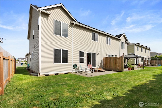 rear view of property featuring a gazebo and a patio