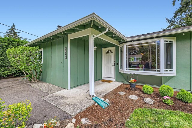 doorway to property featuring board and batten siding