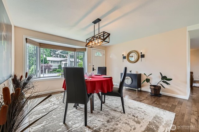 dining area with wood finished floors and baseboards