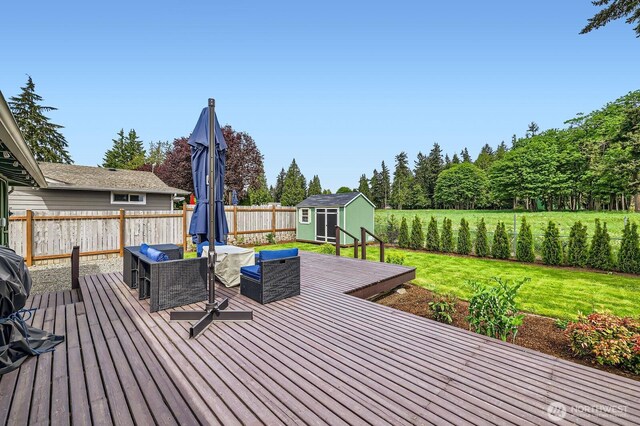 deck featuring a shed, an outbuilding, and outdoor lounge area
