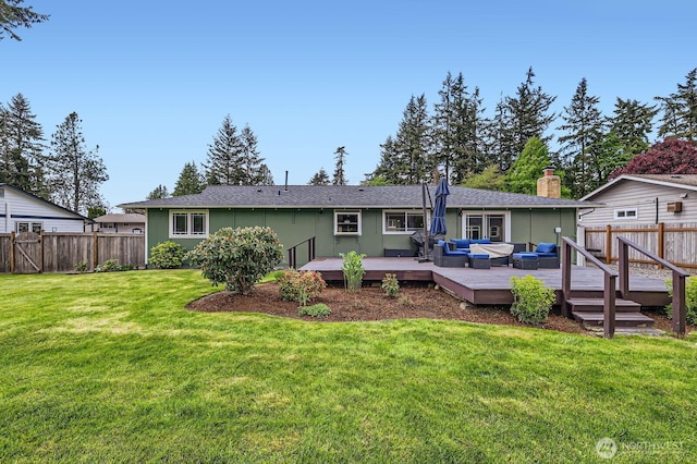 rear view of house featuring outdoor lounge area, a deck, and a chimney