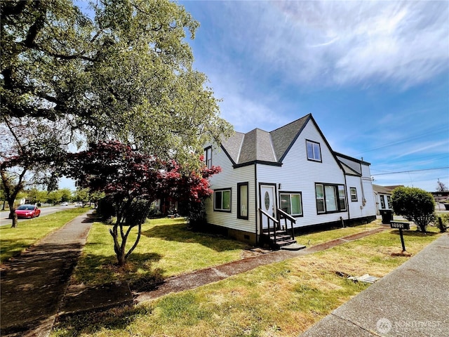 2802 Sumner Ave, Hoquiam, WA 98550 - view of front of house with entry steps, a shingled roof, a front lawn, and crawl space