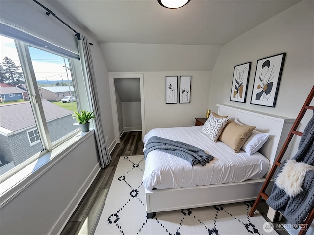 2802 Sumner Ave, Hoquiam, WA 98550 - bedroom with vaulted ceiling, dark wood-style flooring, baseboards, and access to exterior