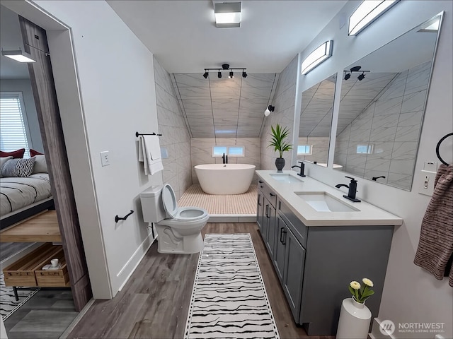 2802 Sumner Ave, Hoquiam, WA 98550 - full bathroom with tiled shower, double vanity, a sink, and wood finished floors