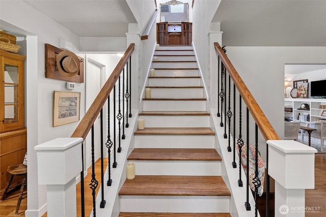 staircase with wood finished floors