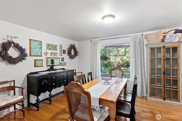 dining area with light wood-style flooring