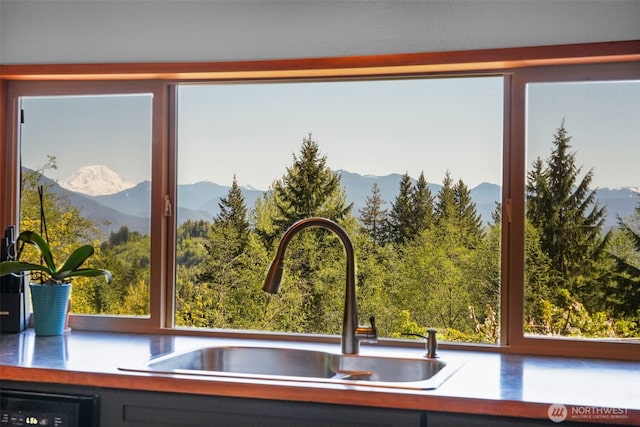 kitchen view of a sink and a mountain view