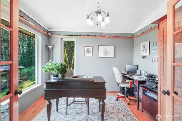 office area with light wood-style floors, plenty of natural light, a chandelier, crown molding, and lofted ceiling