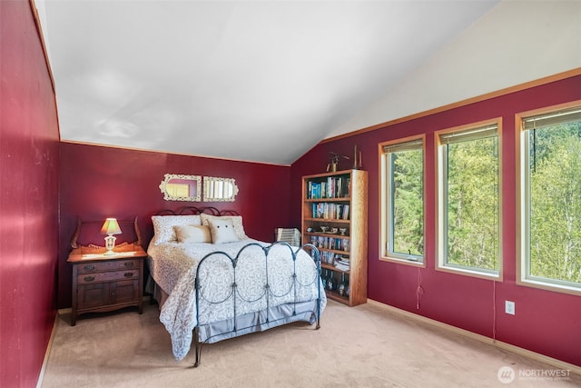 bedroom featuring vaulted ceiling, multiple windows, carpet flooring, and baseboards