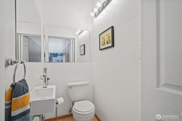bathroom featuring toilet and a sink