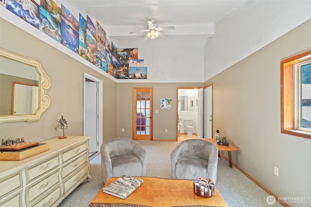 sitting room with a ceiling fan, light carpet, and baseboards