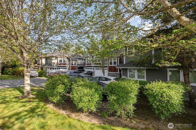 view of green lawn featuring an attached garage