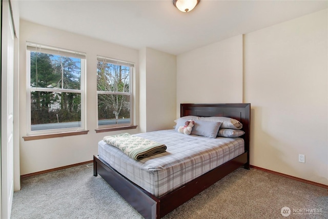 carpeted bedroom with baseboards