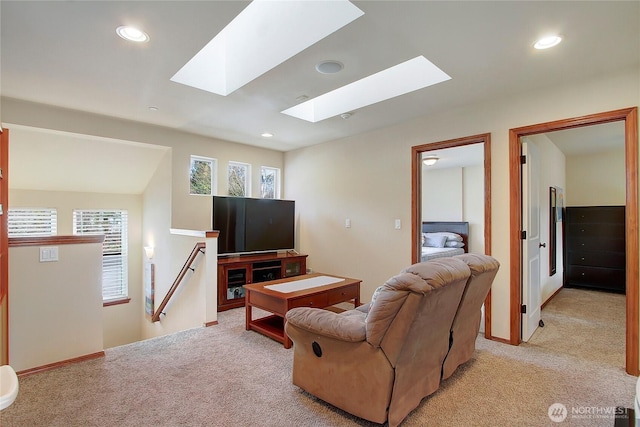 living room with light carpet, a skylight, and recessed lighting