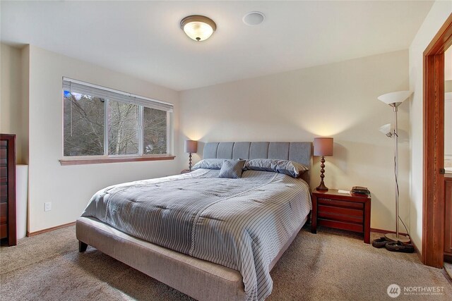 bedroom with carpet and baseboards