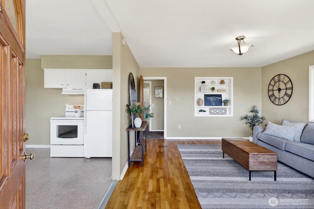 living area with built in features, baseboards, and light wood-style flooring