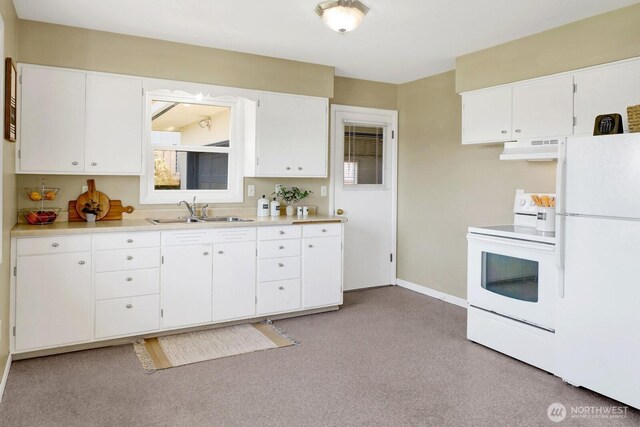 kitchen with a sink, white appliances, under cabinet range hood, light countertops, and baseboards