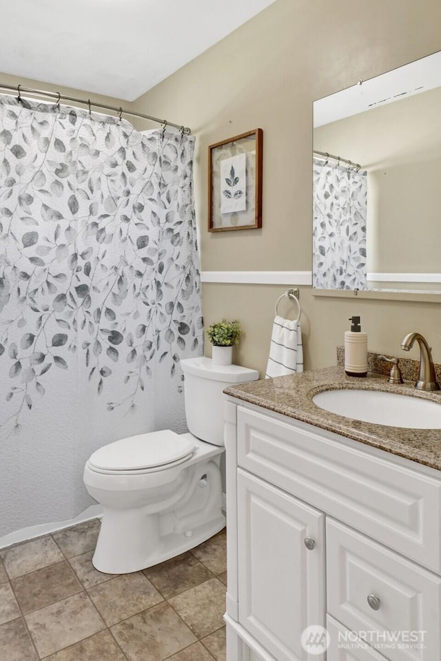 bathroom with toilet and vanity