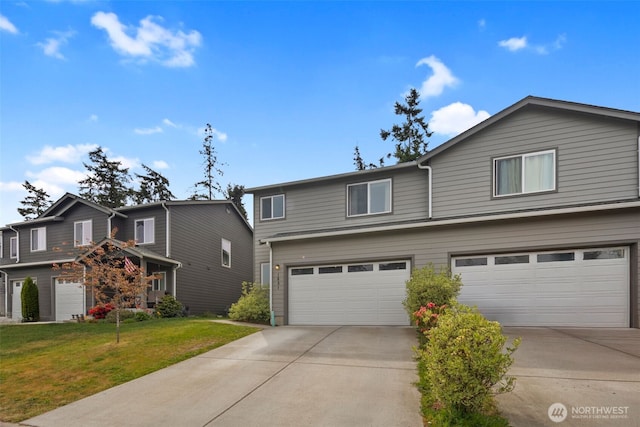 traditional home featuring an attached garage, concrete driveway, and a front lawn
