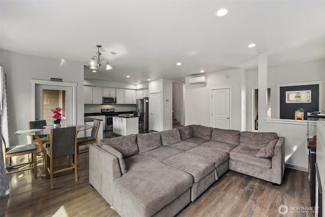 living room featuring dark wood-type flooring, recessed lighting, a wall mounted AC, and stairs