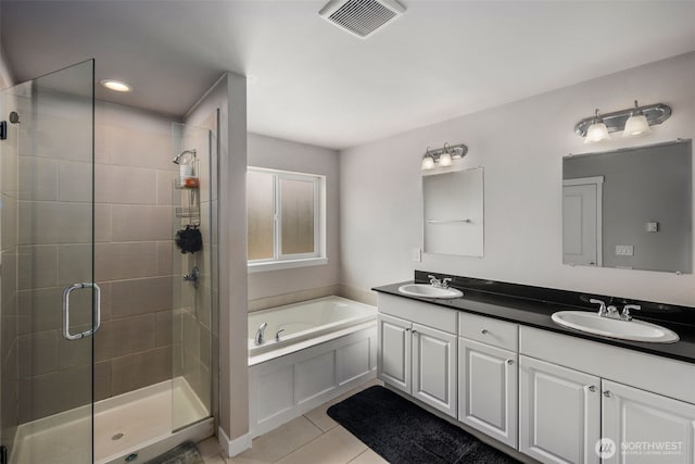 bathroom with a shower stall, a bath, tile patterned flooring, double vanity, and recessed lighting