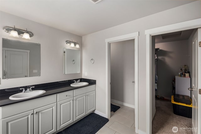 full bathroom with double vanity, tile patterned floors, and baseboards
