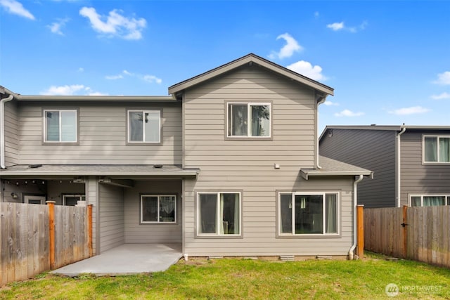 back of property with a patio