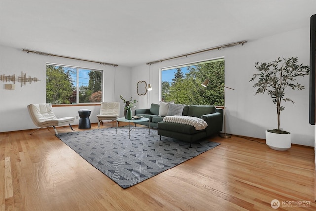 living area with healthy amount of natural light and wood finished floors