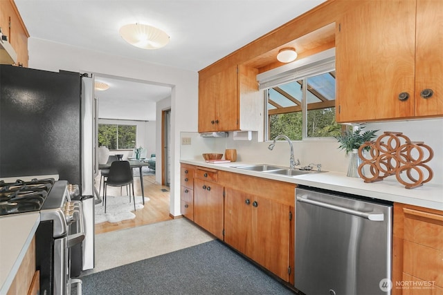 kitchen with stainless steel appliances, light countertops, and a sink