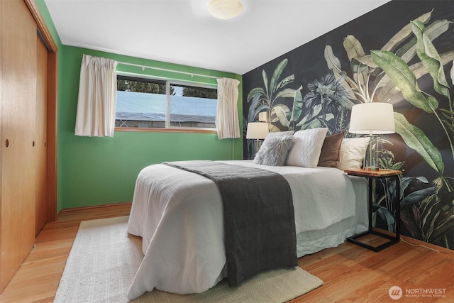 bedroom featuring wood finished floors and a closet