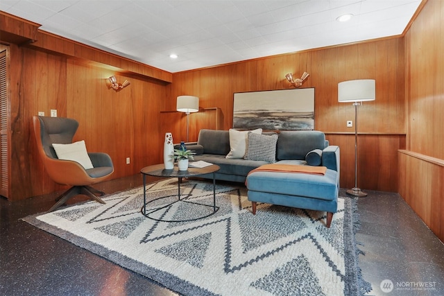 living area featuring wooden walls and recessed lighting