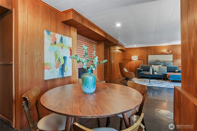 dining space featuring wood walls