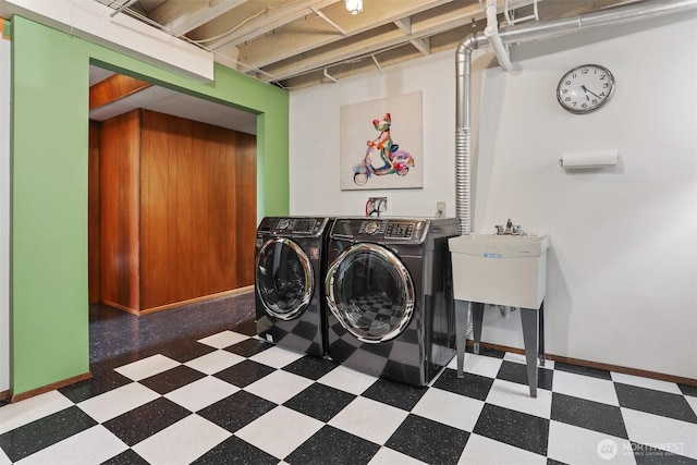washroom featuring tile patterned floors, washing machine and dryer, and baseboards