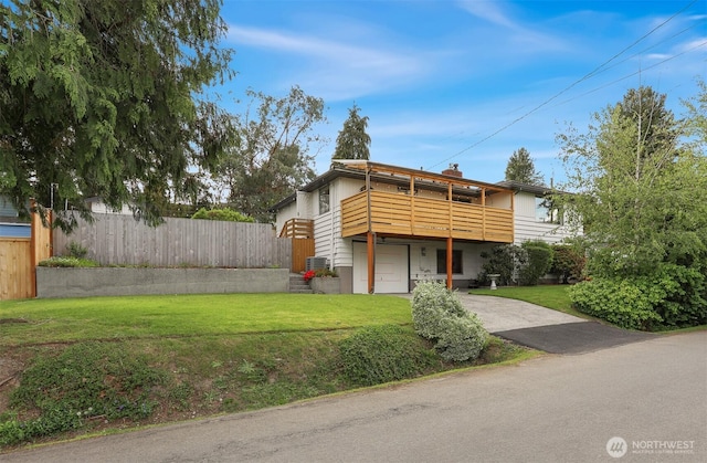 view of front of property with asphalt driveway, a garage, and a chimney