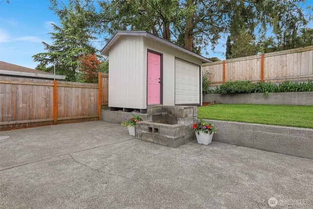 view of outbuilding featuring a fenced backyard and an outbuilding