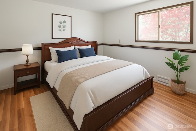 bedroom with light wood-style flooring and baseboards