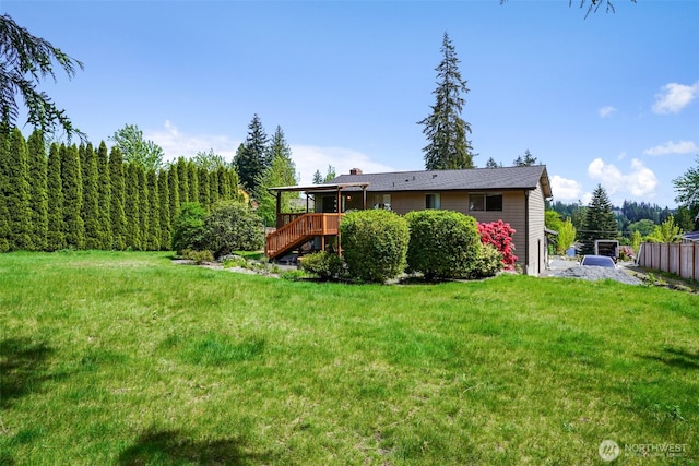 back of house featuring stairs and a wooden deck