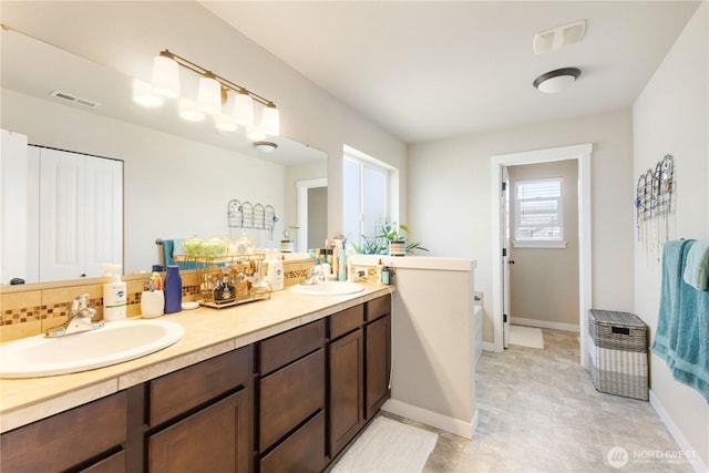 14464 99th Way SE, Yelm, WA 98597 - bathroom with double vanity, a bath, and baseboards