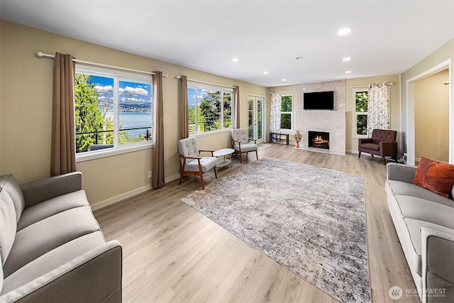 9919 Arrowsmith Ave S, Seattle, WA 98118 - living area featuring a large fireplace, baseboards, light wood-style floors, and recessed lighting