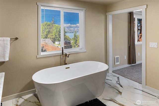 9919 Arrowsmith Ave S, Seattle, WA 98118 - full bathroom featuring marble finish flooring, a freestanding bath, baseboards, and heating unit