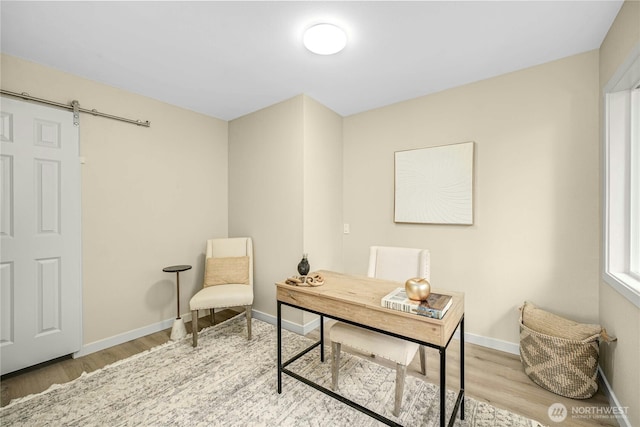 9919 Arrowsmith Ave S, Seattle, WA 98118 - office area with wood finished floors, a barn door, and baseboards