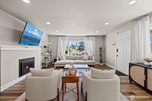 3342 Greenwood Ave W, University Place, WA 98466 - living area featuring recessed lighting, baseboards, a lit fireplace, and wood finished floors