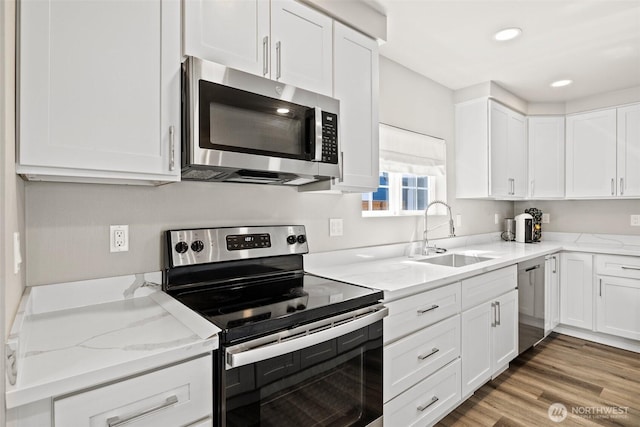 3342 Greenwood Ave W, University Place, WA 98466 - kitchen featuring appliances with stainless steel finishes, a sink, white cabinetry, light stone counters, and recessed lighting