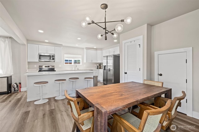 3342 Greenwood Ave W, University Place, WA 98466 - dining space with a chandelier, light wood finished floors, and recessed lighting