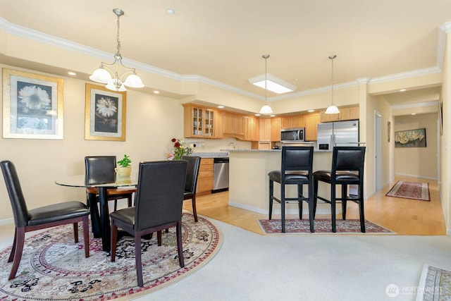 2440 S Steele St Unit 101, Tacoma, WA 98405 - dining space with ornamental molding, a chandelier, and baseboards