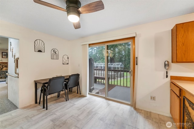 doorway to outside with ceiling fan, light wood finished floors, and wine cooler