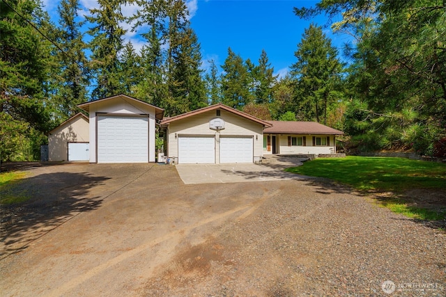 view of front of house with concrete driveway, a garage, and a front lawn
